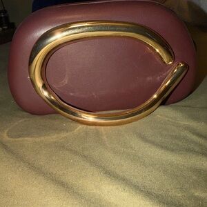 Elegant Burgundy Clutch with Gold Accent